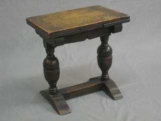A 1930's miniature oak Tudor style drawleaf dining table, raised on bulbous turned supports with H framed stretcher 17"