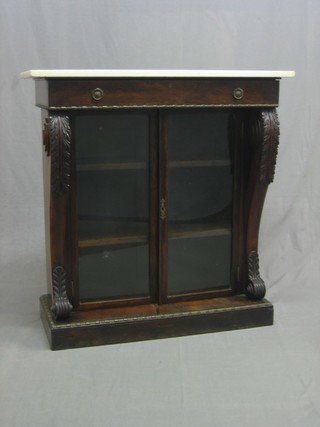 A 19th Century mahogany chiffonier with white veined marble top, the base fitted a drawer, the interior fitted shelves enclosed by glazed panelled doors and with scrolled columns to the sides, raised on a platform base 35"