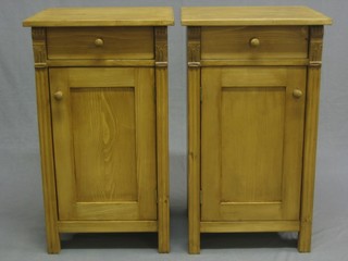 A pair of pine bedside cabinets fitted a drawer above cupboard, 17"