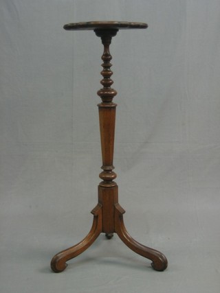 A Victorian Gothic oak torchere, raised on pillar and tripod supports