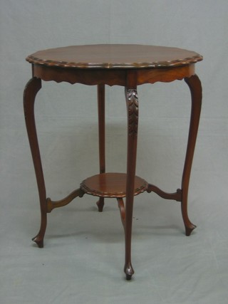 An Edwardian circular mahogany 2 tier occasional table, raised on cabriole supports 23"