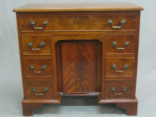 A Georgian style mahogany kneehole dressing table/desk, fitted 1 long drawer above a cupboard flanked by 6 short drawers, raised on bracket feet 31"