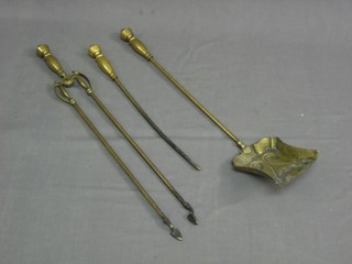 An Art Nouveau brass 3 piece fireside companion set with shovel, tongs and poker 