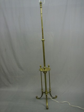 A brass adjustable standard lamp