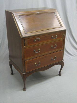 An Edwardian inlaid mahogany bureau the fall front revealing a well fitted interior above 3 long drawers, raised on cabriole supports 27"