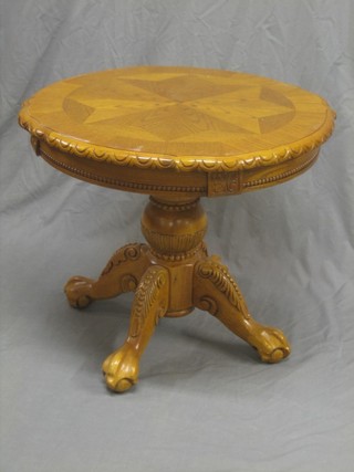 A German style circular carved oak occasional table raised on pillar and tripod supports 29"