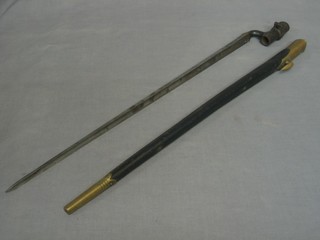 A "Brown Bess" bayonet, the 22" blade marked WD 53E/89 complete with leather and brass mounted scabbard