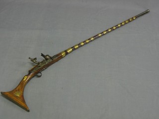 A  Native flintlock giselle with 43" barrel marked Clauih London with 2 crowns, the stock inlaid with brass and ivory 