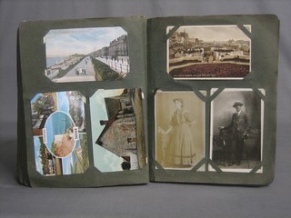 A green card album of various postcards