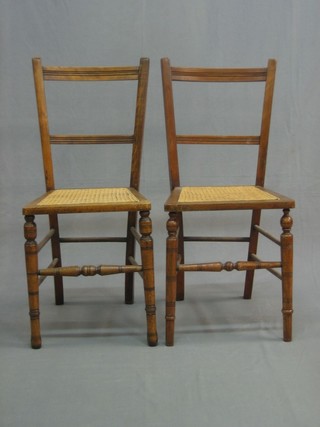 A pair of Victorian satinwood ladderback bedroom chairs with woven cane seats