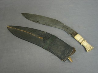 A Kukri with 12 1/2" blade, ivory grip and complete with scabbard