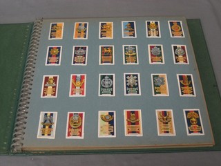 A large green album of various cigarette cards