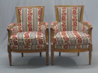 A pair of French style mahogany armchairs upholstered in tapestry material