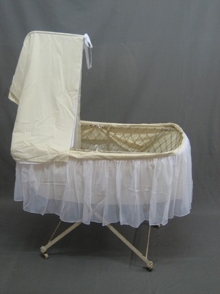 A Victorian oval iron childs crib complete with drapes