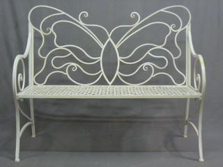 A pierced metal framed bench, the back decorated a butterfly 48"