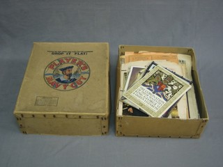 A Player's Navy Cut box containing various vintage newspapers