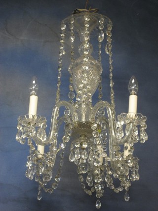A handsome pair of 19th Century 5 branch glass chandeliers hung numerous lozenges
