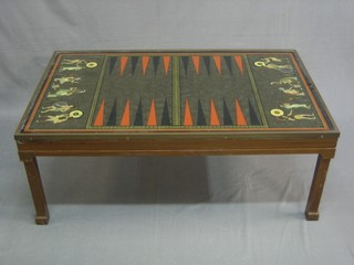 A mahogany framed coffee table, the glass top painted a backgammon board with Grecian scenes, raised on square tapering supports 40"