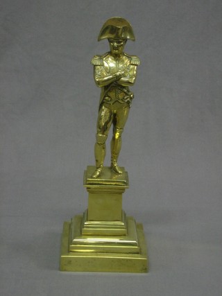 A gilt metal figure in the form of the standing Emperor Napoleon, raised on a square metal base 14"