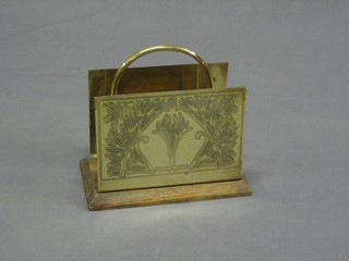 An Art Nouveau rectangular engraved brass and oak twin division letter rack 7"