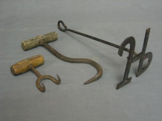 An iron branding iron marked JP and 2 sack hooks