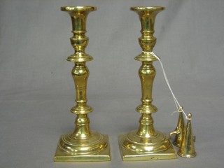 A pair of 19th Century heavy brass candlesticks 9 1/2" and a pair of brass candle snuffers