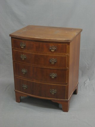 A Georgian style walnut bow front chest of 4 long drawers with swan neck drop handles, raised on bracket feet 24"