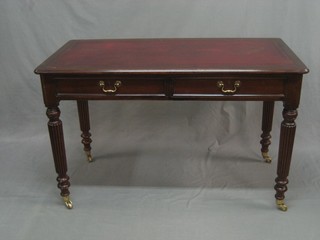 A 19th Century mahogany writing table with inset red leather writing surface, fitted 2 frieze drawers and raised on turned and reeded supports 48"