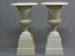 A pair of Victorian style white painted cast iron garden urns of trumpet form with egg and dart borders 18"