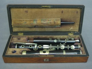 A wooden flute by Kenith Prowse & Co 48 Cheapside London in 3 sections, complete with cleaning brush contained in a rosewood case