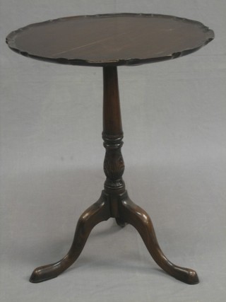 A 19th Century Chippendale style circular snap top wine table, raised on pillar and tripod supports 19"