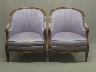 A pair of French style mahogany show frame tub back armchairs, upholstered in blue material