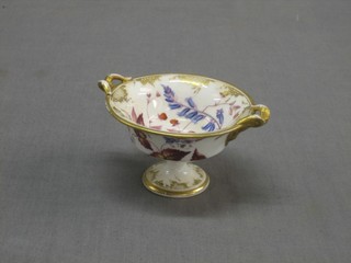 A circular 19th Century miniature porcelain twin handled comport with floral decoration 2 1/2"