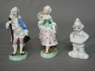 A porcelain figure of a clown 4" and 2 other porcelain figures Lady and Gentleman