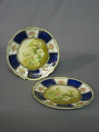 A pair of porcelain plates with floral decoration within blue and gilt banding 8"
