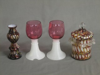 2 cranberry glasses with opaque glass stems, an End of Day glass jar and cover and a do. vase