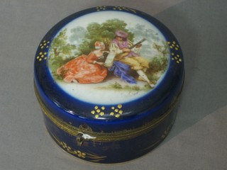 A circular Continental porcelain blue glazed trinket box with hinged lid 4"