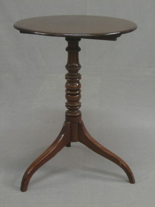 A 19th Century circular mahogany snap top wine table, raised on a turned column 21"