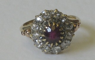 An 18ct yellow gold dress ring set a ruby surrounded by diamonds