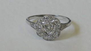 An 18ct white gold dress ring set a diamond surrounded by diamonds and with diamonds to the shoulders, approx 0.50ct