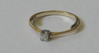 A gilt metal dress ring set a white stone