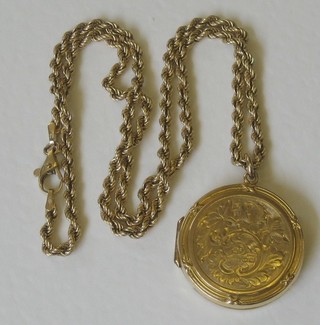 A 9ct gold engraved locket hung on a 9ct gold chain