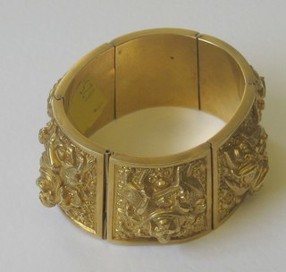 An Eastern gilt metal bangle decorated Deitys