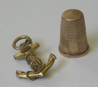 A gilt metal thimble and a 9ct gold brooch in the form of an anchor