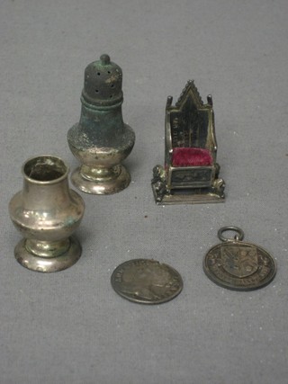 A miniature silver model of the Coronation Throne, a Queen Anne silver Shilling? 1711, a silver watch chain medallion and 2 miniature silver pepperettes (1 lid missing)