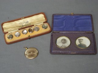 6 gilt metal dress studs, boxed, a gilt cased double sided photo locket and a leather covered locket case