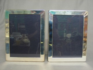 A pair of modern plain silver easel photograph frames 8" x 6 1/2"
