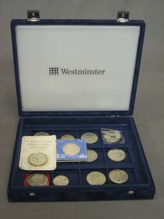 A collection of silver coins contained in a in plush box