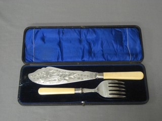 A pair of silver plated fish servers with engraved blades, cased