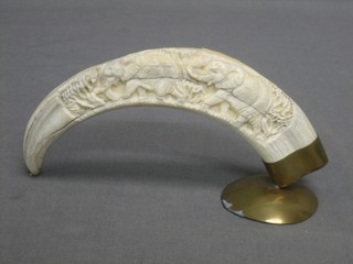 A section of carved ivory raised on a brass stand 6"